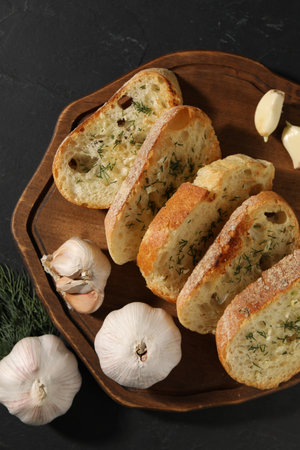Tasty baguette with garlic and dill on gray table, top viewの写真素材