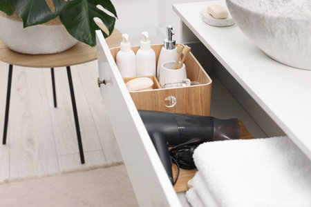 Different bath accessories and personal care products in drawer indoorsの写真素材