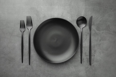 Empty plate and cutlery on gray table, flat layの写真素材
