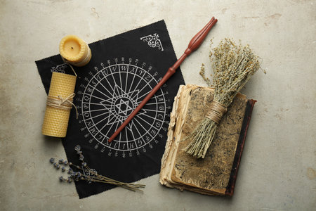 Flat lay composition with magic wand and divination cloth on light textured background