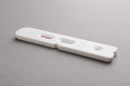 Disposable express test on gray background, closeup