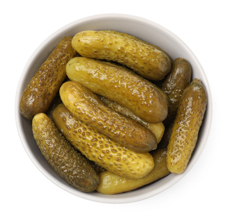 Tasty pickled cucumbers in bowl isolated on white, top viewの写真素材