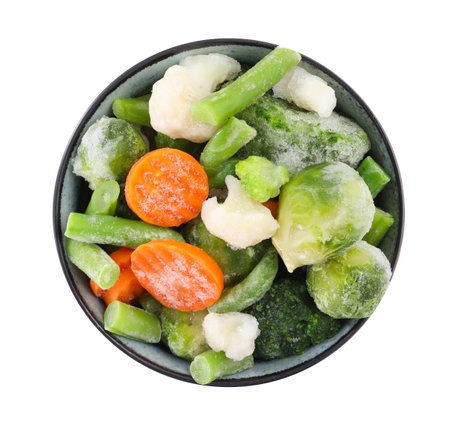Mix of different frozen vegetables in bowl isolated on white, top viewの写真素材
