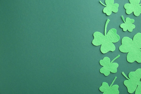 St. Patrick's day. Decorative clover leaves on green background, flat lay. Space for textの写真素材