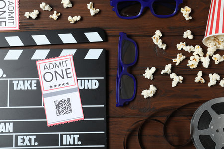 Flat lay composition with clapperboard, cinema tickets and 3d glasses on wooden tableの写真素材