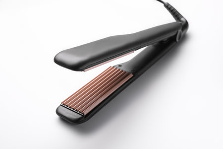 Modern corrugated hair iron isolated on whiteの写真素材