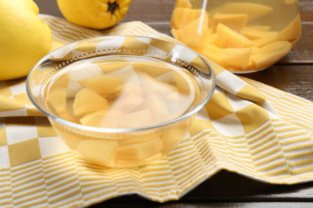 Delicious quince drink and fresh fruits on wooden table, closeup