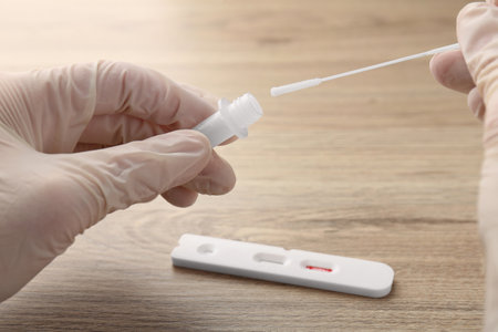 Doctor making laboratory testing at wooden table, closeup