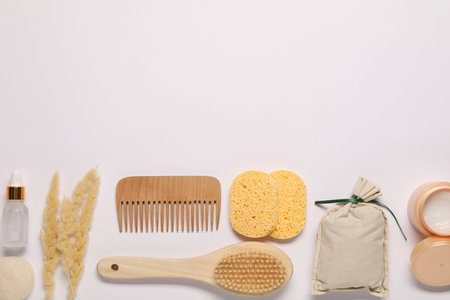 Bath accessories. Different personal care products and dry spikelets on white background, flat lay with space for textの写真素材