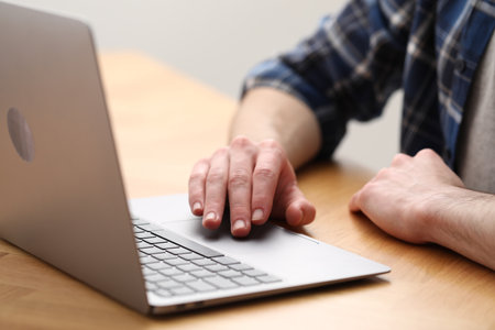 E-learning. Man using laptop during online lesson at table indoors, closeupの写真素材