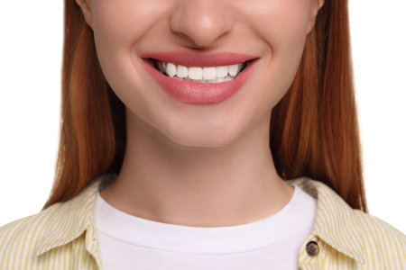 Woman with clean teeth smiling on white background, closeup