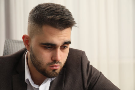 Portrait of sad businessman on blurred backgroundの写真素材