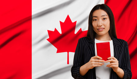 Immigration. Woman with passport against national flag of Canada, space for text. Banner designの写真素材