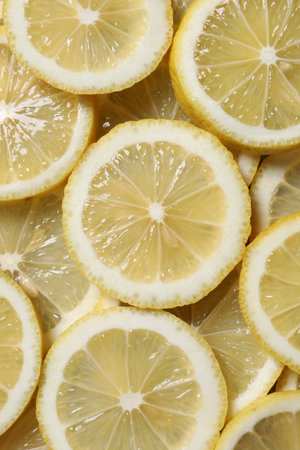 Slices of fresh lemons as background, top viewの写真素材