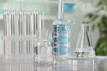 Laboratory analysis. Different glassware with liquid on white table indoorsの写真素材