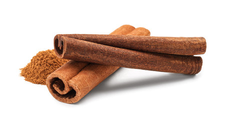 Dry aromatic cinnamon sticks and powder isolated on whiteの写真素材