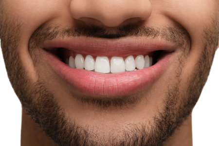 Smiling man with healthy clean teeth on white background, closeup