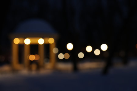 Gazebo and snow in evening park, blurred viewの写真素材