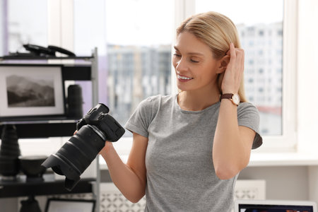 Professional photographer with modern digital camera in officeの写真素材