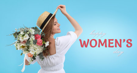 Happy Women's Day, Charming lady holding bouquet of beautiful flowers on light blue backgroundの写真素材