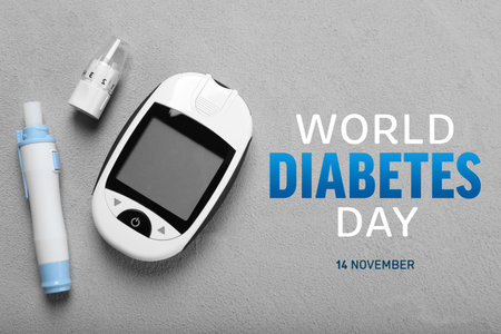 World Diabetes Day. Digital glucometer and lancet pen on gray table, flat layの写真素材