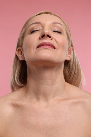 Beautiful woman with healthy skin on pink backgroundの写真素材