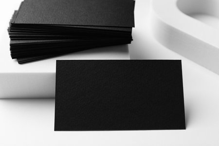 Blank black business cards on white background, closeup. Mockup for designの写真素材