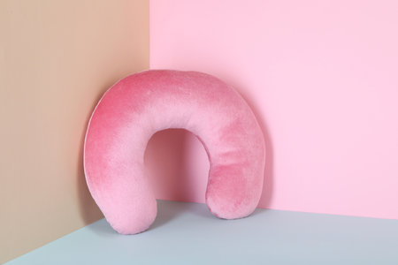Soft pink travel pillow on color backgroundの写真素材