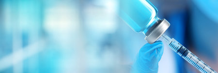 Doctor filling syringe with medication from glass vial on blurred background, closeup. Banner designの写真素材