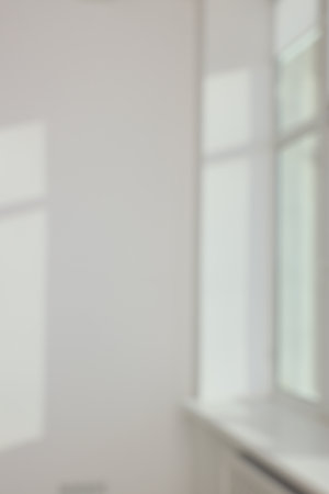 Light and shadows from window on wall indoors