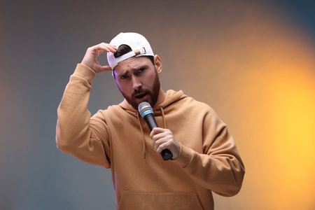 Singer with microphone rapping in color lights