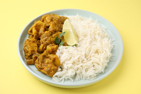 Delicious chicken curry with rice on yellow background, closeupの写真素材