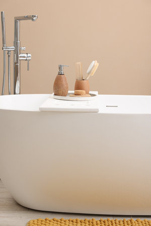 Different personal care products and accessories on bath tub in bathroomの写真素材