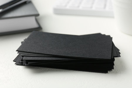 Blank black business cards on white table, closeup. Mockup for designの写真素材
