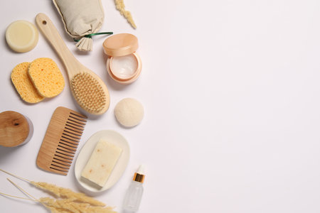 Bath accessories. Different personal care products and dry spikelets on white background, flat lay with space for textの写真素材