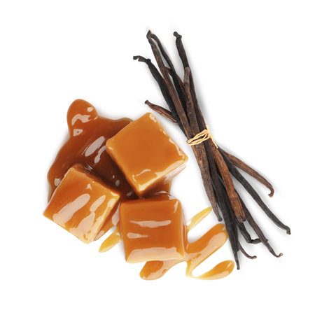 Sweet caramel candies and vanilla pods isolated on white, top viewの写真素材