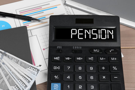 Calculator with word Pension, document, money and stationery on wooden table, closeupの写真素材