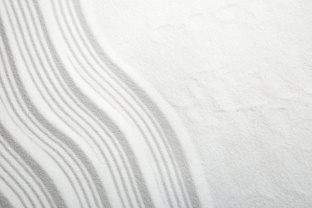 Zen rock garden. Wave pattern on white sand, top viewの写真素材