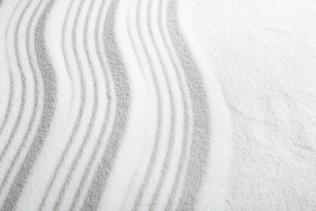 Zen rock garden. Wave pattern on white sand