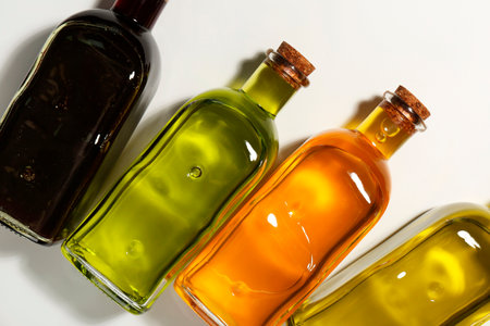 Vegetable fats. Different cooking oils in glass bottles on white background, flat layの写真素材