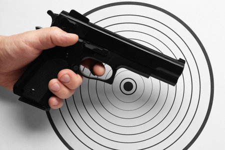 Man with handgun near shooting target, top view