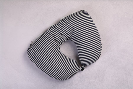 Striped travel pillow on light gray table, top viewの写真素材