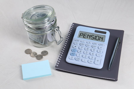 Calculator with word Pension, money and stationery on light gray tableの写真素材