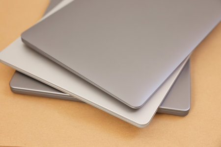 Different modern laptops on brown background, closeupの写真素材