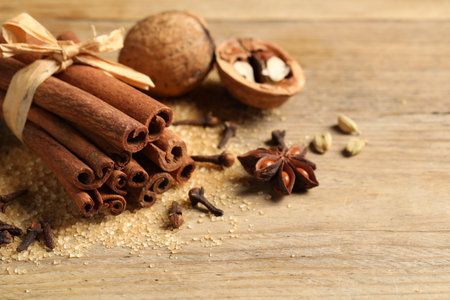 Different spices and nuts on wooden table, closeupの写真素材