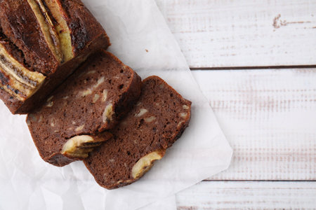 Delicious banana bread on white wooden table, top view. Space for textの写真素材