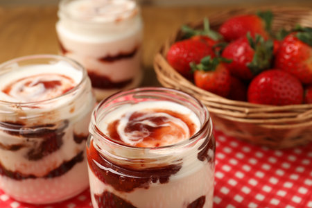 Tasty yoghurt with jam and strawberries on table, closeupの写真素材