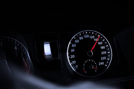 Speedometer on car dashboard, closeup. Motion blur effect
