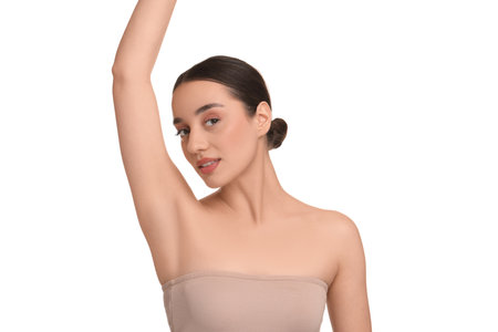 Beautiful woman showing armpit with smooth clean skin on white backgroundの写真素材