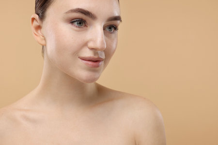 Portrait of beautiful woman on beige background, closeup. Space for textの写真素材